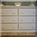 F49. Six-drawer white chest. 34”h x 56”w x 18”d 